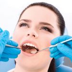 Contemporary-Ortho_14729993-dentist-examines-the-dentes-of-the-patient-on-the-dentist