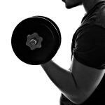 Cure-Fitness_8482027-back-lit-silhouette-of-a-young-man-lifting-weights-in-black-and-white