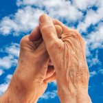 Hall-Longevity_6557222-senior-woman-s-hands-over-sky