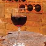 Page-6-VERITCAL_2757551-glass-of-red-wine-on-rustic-wooden-table-in-winery