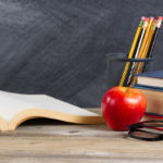 Desktop with reading materials and blackboard