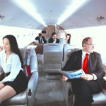 Business people flying on private jet