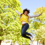 happy african american young woman in summer park