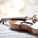 Vintage memories musical score and a violin with bokeh light effect Generative AI Illustration