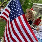 A reveler proudly waves the American Flag