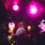 Microphone on stage against a background of auditorium.