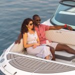 Couple sitting in the bow of an SDX 270 Outboard