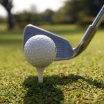 Golf balls and Driver on green grass background