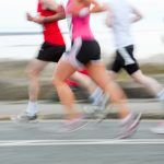 group of runners compete in the race, blurred motion